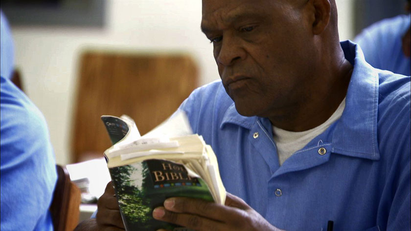 Prisoner reading bible