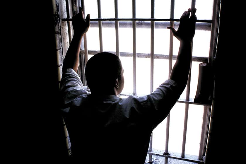 prisoner looks out of cell door