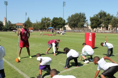 Angel Tree Football Clinic participants run drills.