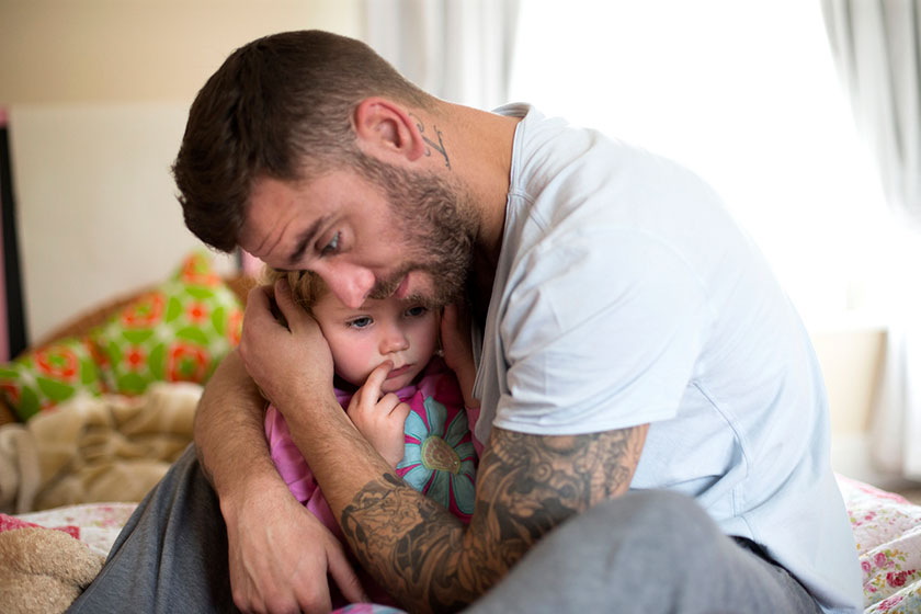 father comforts daughter