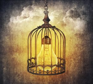 Light bulb locked in a old cage. Locked idea concept