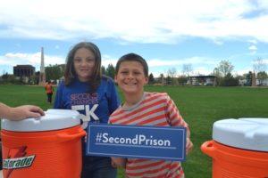 Kids holding second prison sign at CO