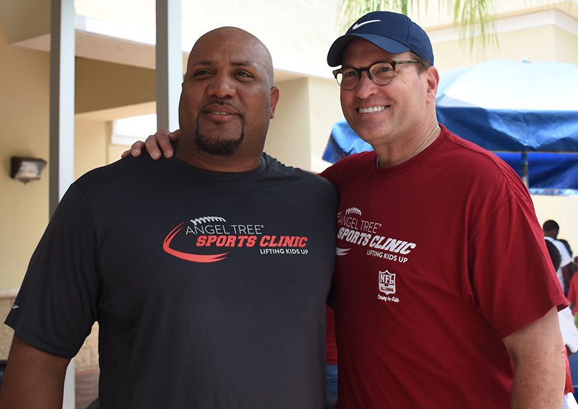 Tyrus McCloud, left, poses for a photo with Prison Fellowship’s director of communications,
Jim Forbes, at a recent Angel Tree Sports Clinic. nfl player volunteer