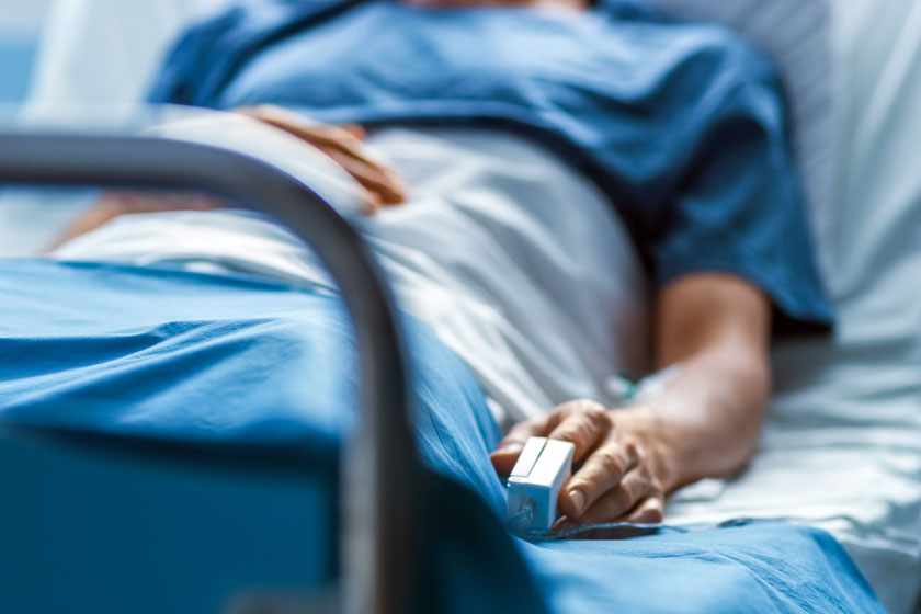 patient sits in hospital bed