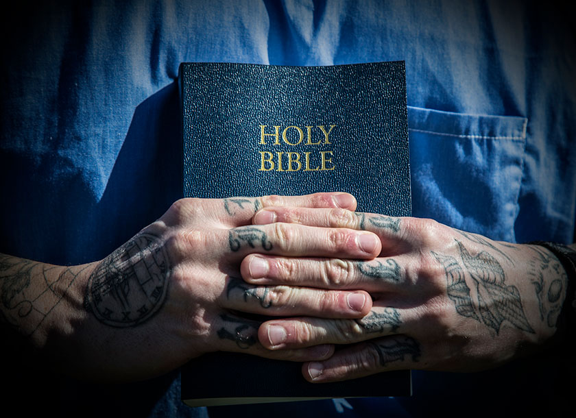 prisoner clutches bible