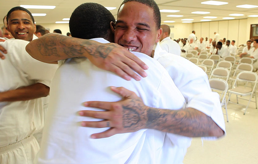 two prisoners hug each other