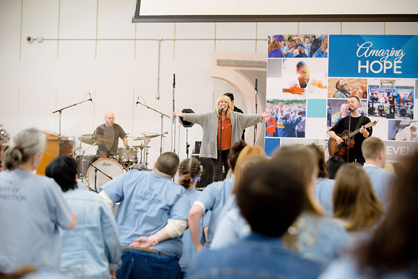 prisoners worship during a song led by Natalie Grant