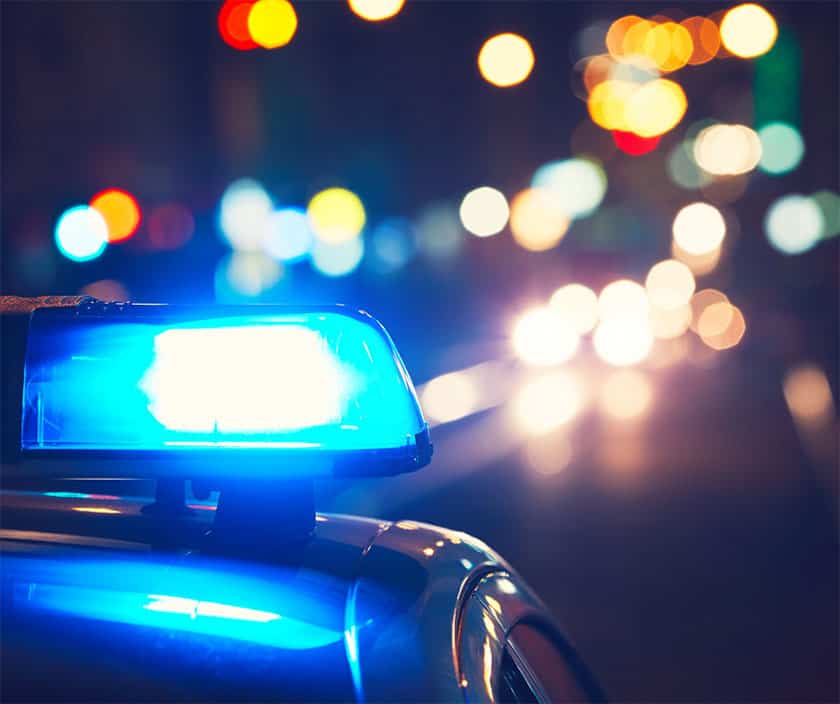 police lights flash at night