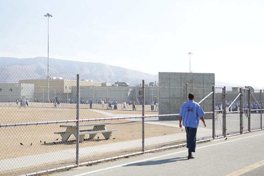 prisoner walks along the prison yard