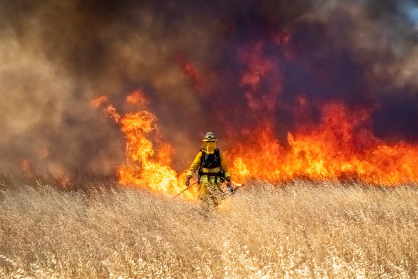 Firefighter walks toward fire in California