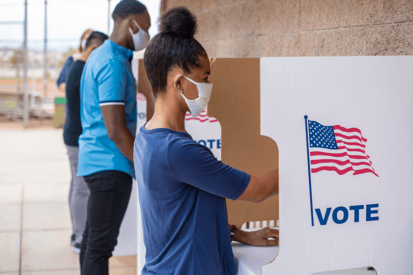 Americans vote at their local polling station wearing face masks to protect themselves from COVID-19.