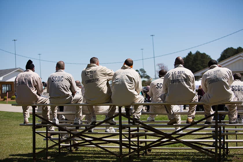 prisoners sit on bleachers on the yard in south carolina