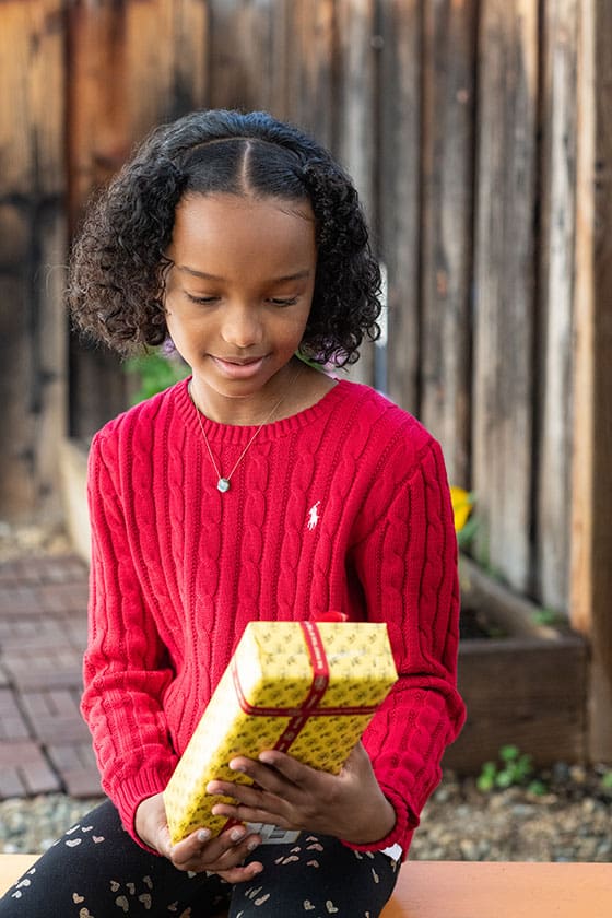 black girl holding christmas present