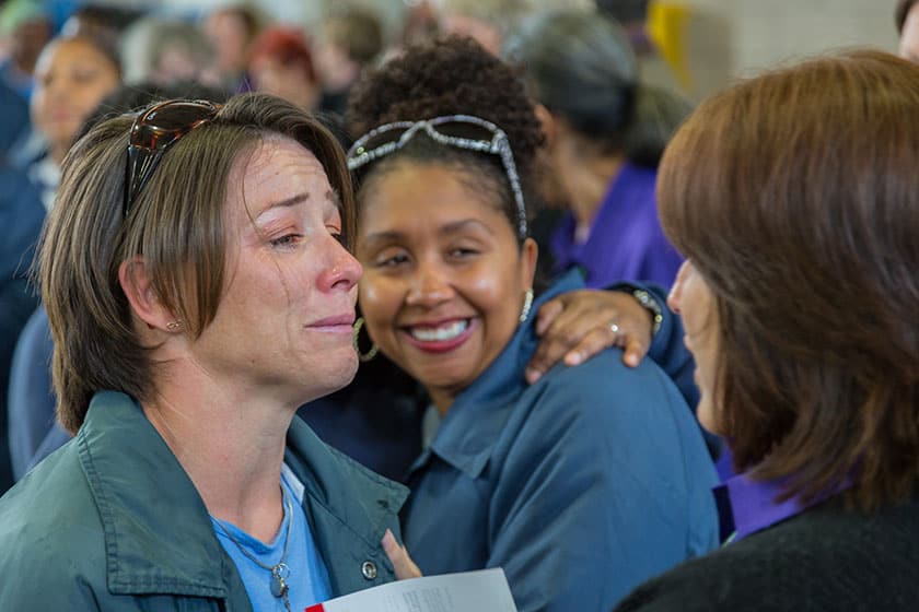 incarcerated women hug and cry together